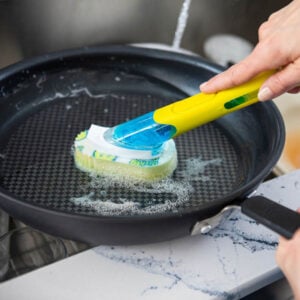 Yellow Dish Daddy cleaning frying pan