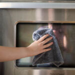 Using a Microfiber Cloth to clean oven door