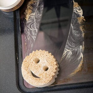 Dye-Free Scrub Mommy dirty from cleaning oven door window with PowerPaste